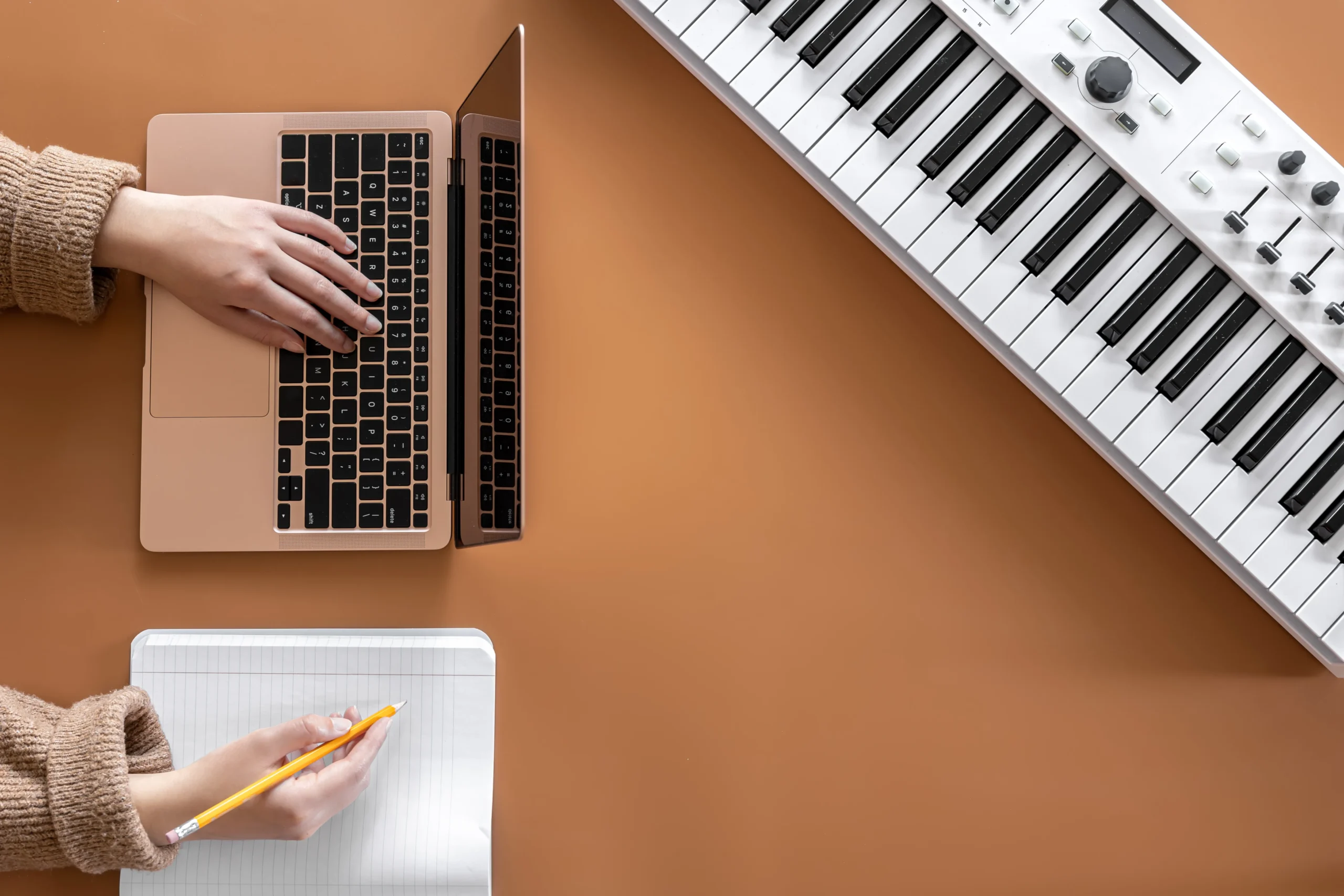 Computer screen showing free piano sheet music websites with piano in background