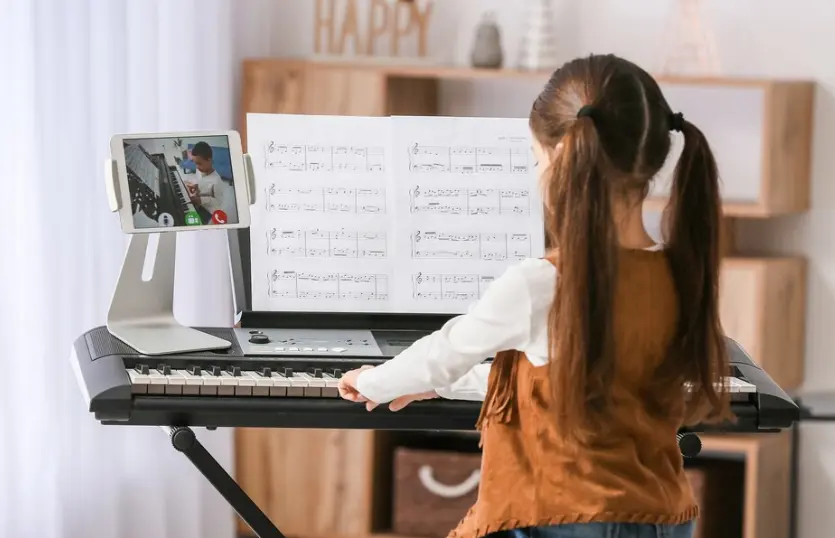 Free beginner piano sheet music displayed on a music stand with piano keys in the background, symbolizing a joyful music learning experience.