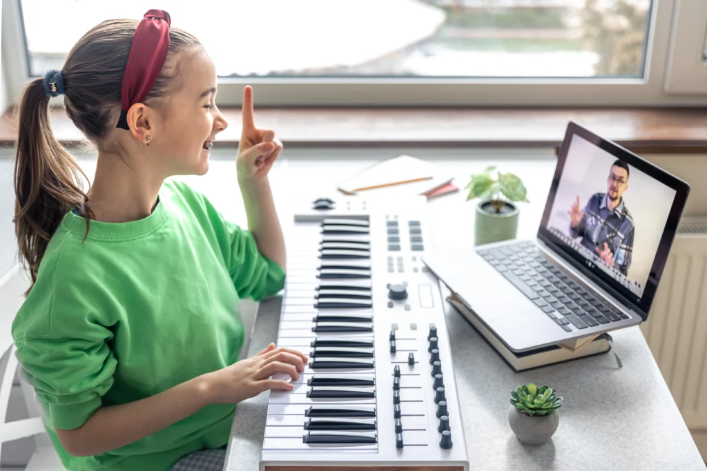 Young student learning piano songs for free online