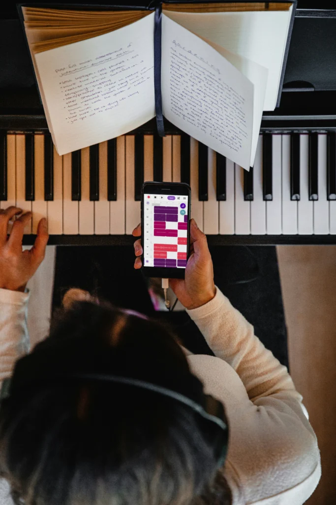Person using piano sheet music apps to capture improvised melody