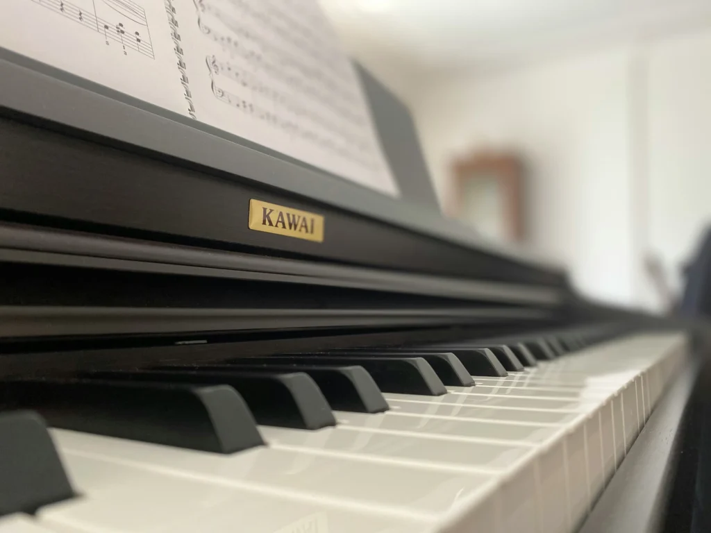 Family playing piano with printed sheet music from Simply Piano app