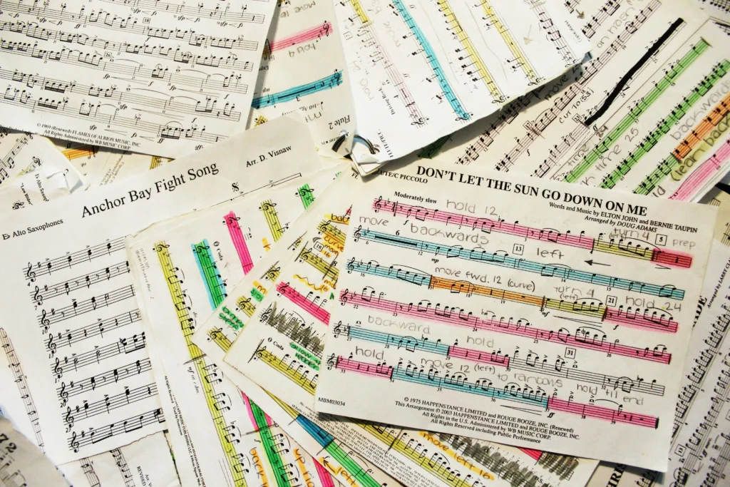 Composer working on creating original sheet music at piano