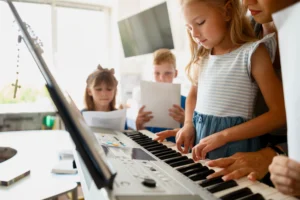 Beginner pianist learning easy sheet music songs like nursery rhymes and simple hymns