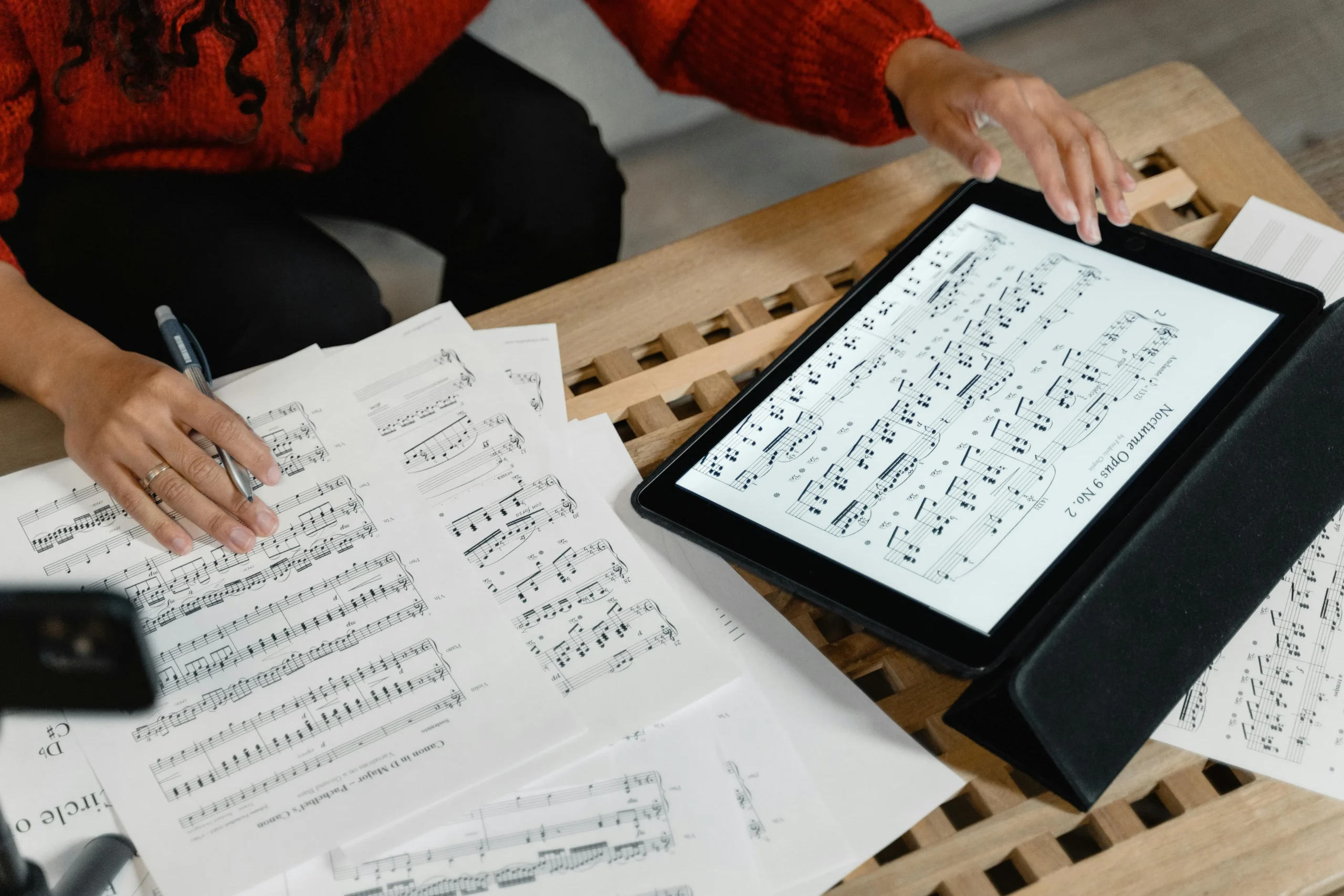 Printed piano sheet music and tablet with digital piano sheet music