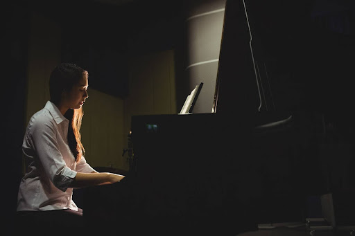 Pianist playing "Clair de Lune" on a grand piano in soft lighting
